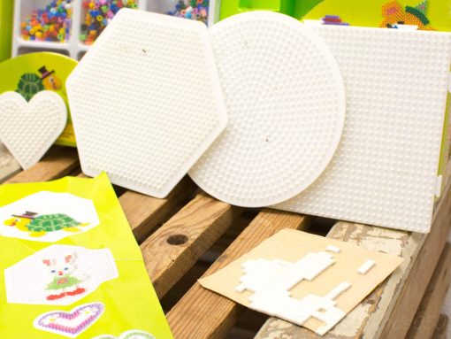 Colorful crafting space with pegboards, beads, and templates for creative artistic projects.
