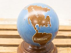 Classic vintage globe with wooden base, showcasing North and South America in rich colors.