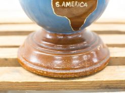 Vintage globe on wooden base highlighting South America, perfect for educational decor.