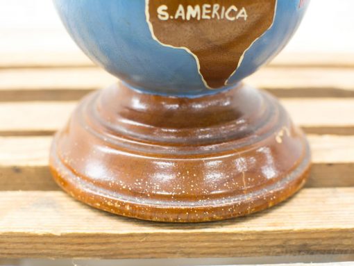 Vintage globe on wooden base highlighting South America, perfect for educational decor.