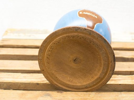 Decorative globe highlighting South America with a glossy finish and rustic wooden base.