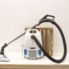 Sleek white vacuum cleaner with blue accents, designed for efficient and stylish home cleaning.