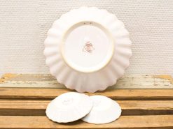 Elegant ceramic plates with scalloped edges, perfect for dining and decorative displays.