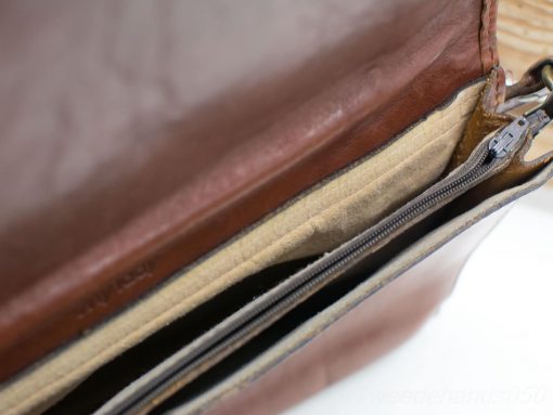 Stylish brown leather shoulder bag with organized interior and quality craftsmanship for everyday use.