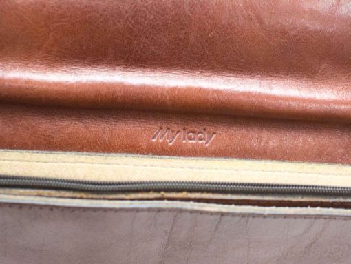 Elegant cognac leather shoulder bag with personalized My Lady inscription and refined detailing.