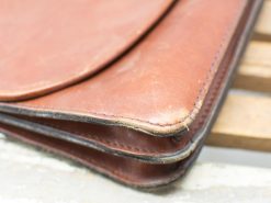 Stylish vintage brown leather bag with unique character and timeless design.