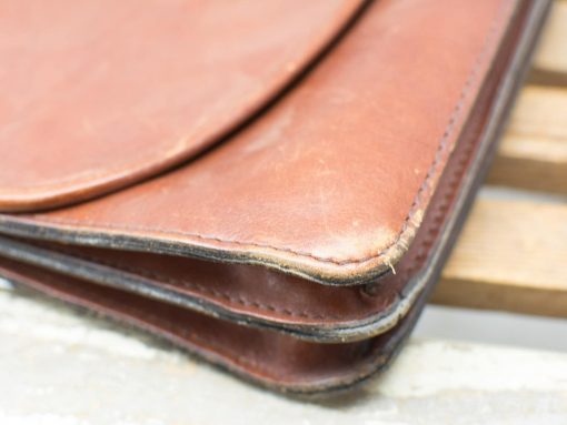 Stylish vintage brown leather bag with unique character and timeless design.