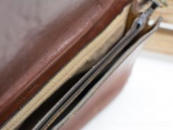 High-quality cognac leather shoulder bag with organized compartments and durable zippers.