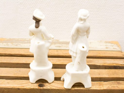 Elegant vintage porcelain figurines of a man and woman, perfect for collectors and antique lovers.