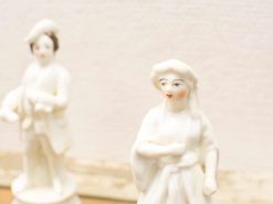 Elegant porcelain couple figurines showcasing fine craftsmanship and detailed artistry.