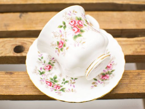 Elegant vintage teacup and saucer with pink roses and gold accents, perfect for tea lovers.