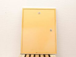 Functional yellow door on wooden pallet, ideal for storage spaces or workshops.