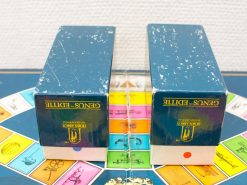 Vintage Genus S. Editi board game set with colorful game board and elegant blue boxes.
