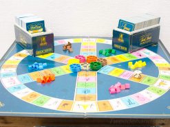 Colorful Genus board game on a wooden table, featuring vibrant segments and playful pieces.