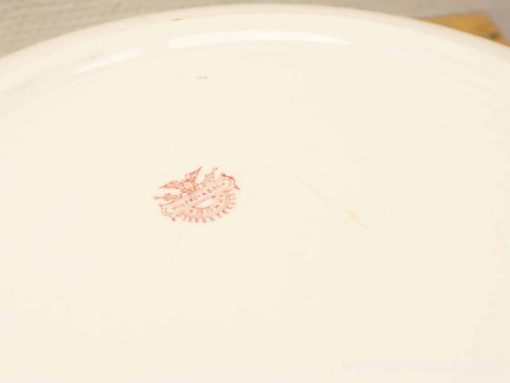 Elegant vintage ceramic plate featuring a distinctive red makers mark, perfect for collectors and decor.