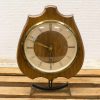 Elegant vintage wooden table clock with Roman numerals, perfect for adding charm to any space.
