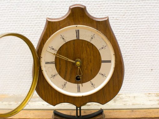 Charming vintage wooden clock with Roman numerals and pendulum, perfect for timeless home decor.