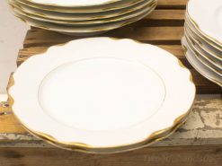 Elegant vintage white plates with a delicate gold rim, perfect for special occasions.