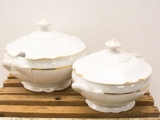 Elegant porcelain soup tureens with gold accents, perfect for special occasions and dining decor.