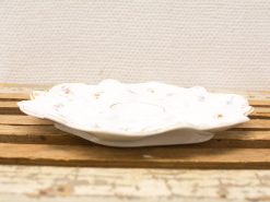 Elegant vintage porcelain dish with delicate floral design, perfect for serving snacks or decoration.