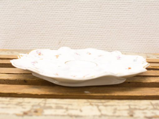 Elegant vintage porcelain dish with delicate floral design, perfect for serving snacks or decoration.