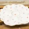 Elegant porcelain plate with floral design and golden rim, perfect for serving or decoration.