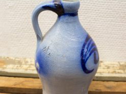 Artisan ceramic jug with pale blue finish and dramatic dark blue swirl design.