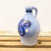 Elegant blue ceramic jug with intricate patterns, perfect for serving or decorative use.