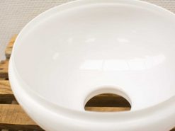 Elegant white bowl with hole, perfect for decor or practical uses like planting.