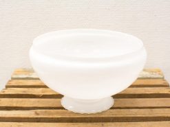 Elegant translucent bowl with rustic wooden base, perfect for decor or serving.