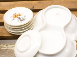 Elegant vintage porcelain plates with floral patterns, perfect for stylish dining experiences.