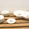 Elegant porcelain dishware set with floral patterns, perfect for special occasions and gatherings.