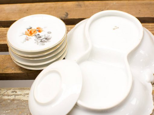 Elegant vintage porcelain plates with floral patterns, perfect for stylish dining experiences.
