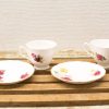 Charming vintage tea cups with floral designs, perfect for afternoon tea or decor.
