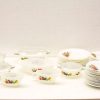 Elegant white kitchenware set with vibrant fruit designs for everyday and special occasions.