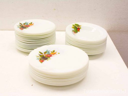 Charming vintage plates with vibrant fruit and floral designs, ideal for any dining occasion.