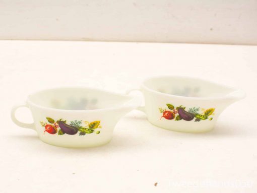 Charming vintage gravy boats with botanical designs in milky glass, perfect for festive meals.