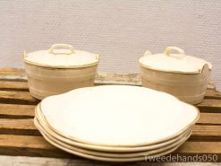 Elegant vintage ceramic dishes with gold rim, perfect for nostalgic table settings and special occasions.