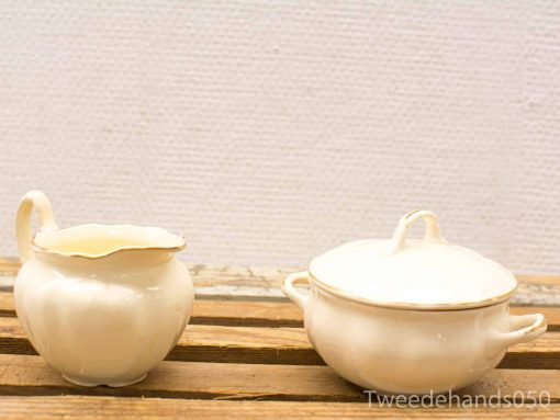 Elegant porcelain creamer and covered dish set for refined tea service and decor.