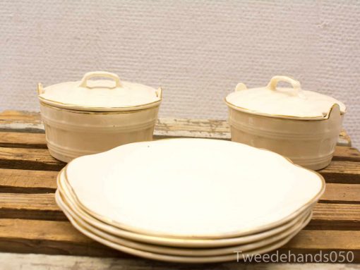 Elegant vintage ceramic dishes with gold rim, perfect for nostalgic table settings and special occasions.