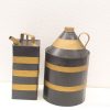Vintage black metal containers with gold stripes, perfect for rustic decor and liquid storage.