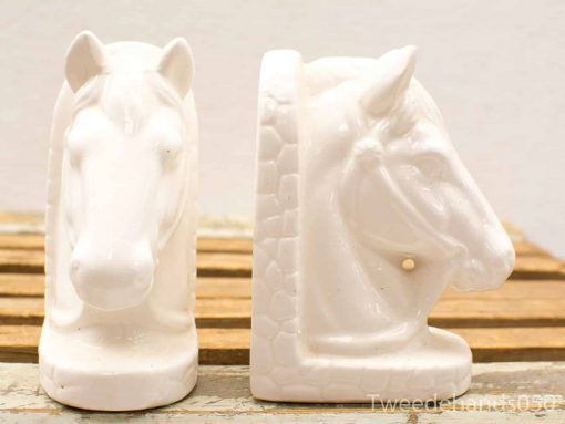 Elegant white ceramic horse head bookends, perfect for decor and organizing books.