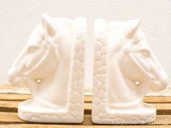 Elegant white ceramic horse head bookends, perfect for stylish home decor and organization.