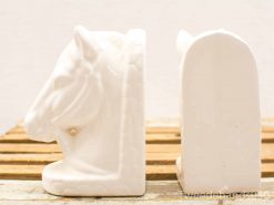 Elegant vintage white horse head bookends for stylish book organization and décor.