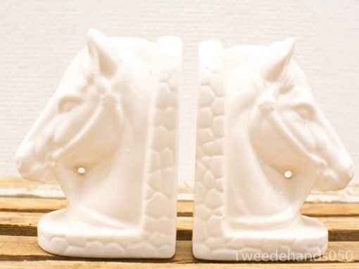Elegant white ceramic horse head bookends, perfect for stylish home decor and organization.
