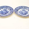 Elegant blue and white decorative plates featuring intricate landscape designs, perfect for collectors and dining.