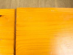 Warm polished pine wood surface with rich grain, perfect for cozy interiors and everyday use.