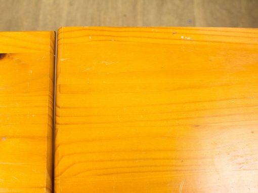 Warm polished pine wood surface with rich grain, perfect for cozy interiors and everyday use.