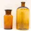 Stylish vintage amber glass bottle set, perfect for decor or unique collectibles.