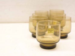 Sophisticated amber glass tumblers by Luminarc, featuring elegant design and contrasting black rims.
